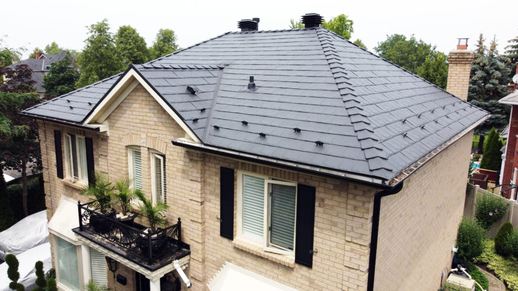Colour-matched snow guards along the lower edges of an Armadura Crinkle Eclipse metal roof in Mississauga.
