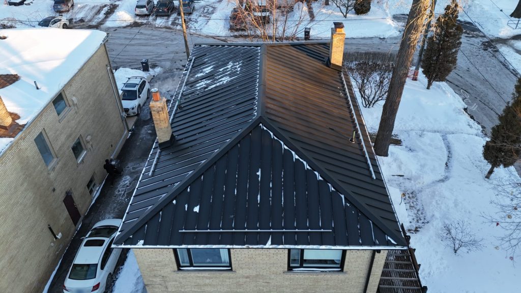 Black standing seam steel roof with snow guards on the same Mississauga home